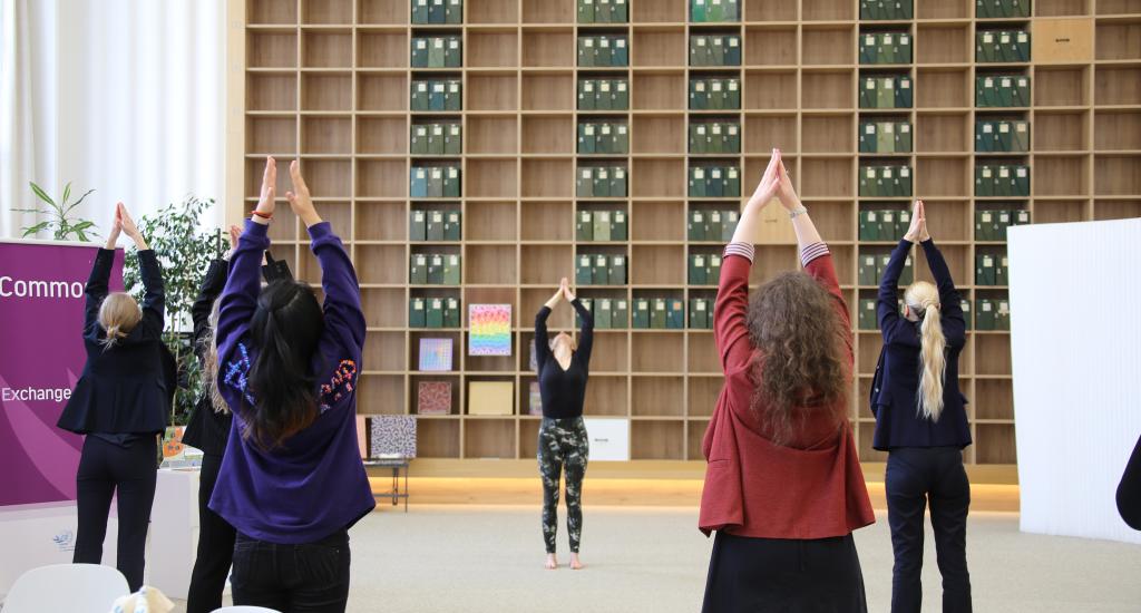 Picture of the audience doing yoga.