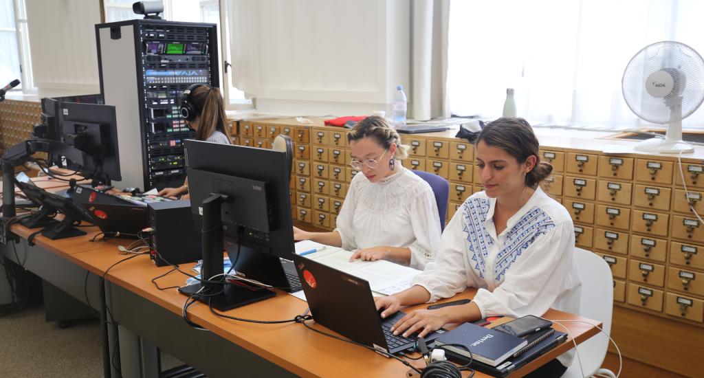 Picture of three women taking of the technical aspects of event