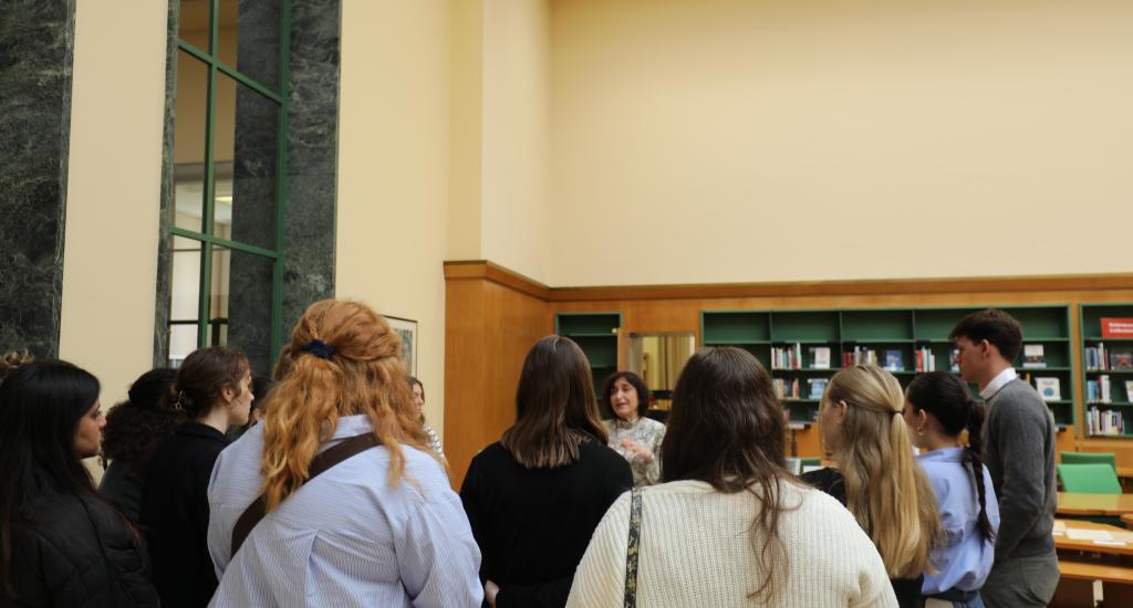 The students visit the Library. This image shows the students listening to a librarian as she explains the history of the Library.