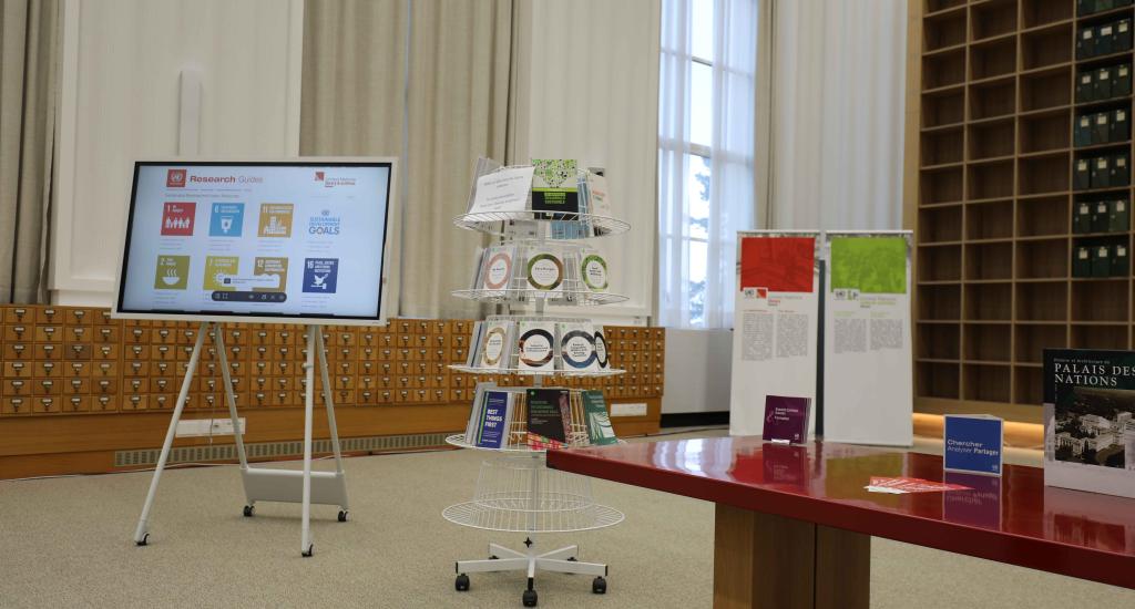 This photo shows a TV screen displaying the SDG Resource Guide by the UN Library & Archives Geneva, and books related to the Sustainable Development Goals.