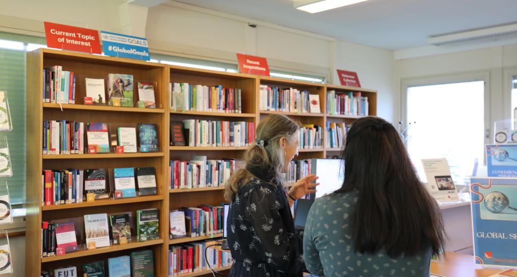 A Library colleague supports a user in the Main Reading Room.