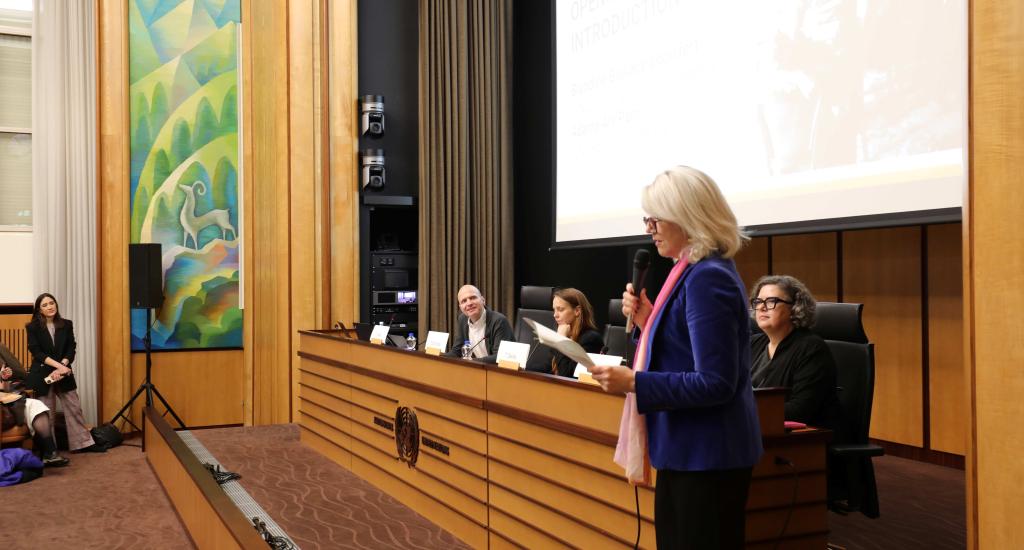 Blandine Blukacz-Louisfert welcomes the audience for the launch of the book Intellectual Cooperation at the League of Nations in Room 14 at the Palais des Nations.