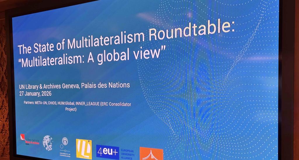 A photo of the screen in the meeting room with the title of the roundtable: "The State of Multilateralism Roundtable - Multilateralism, A Global View".