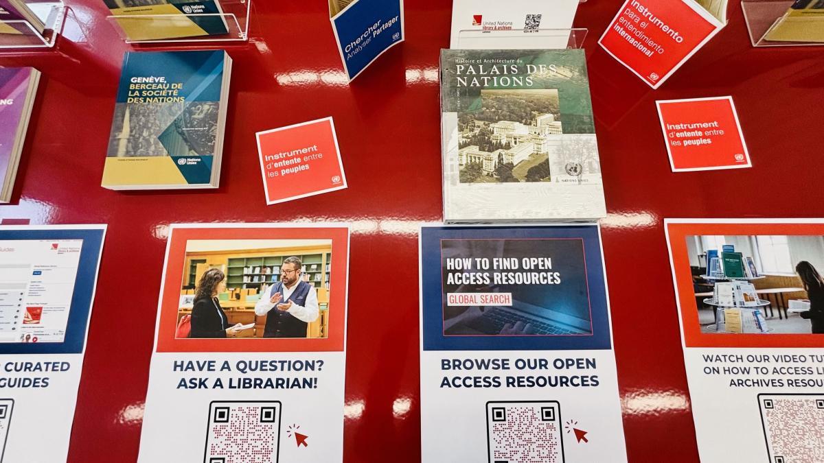 This image shows a large red table featuring posters and links to the Library's open access resources and digital services.
