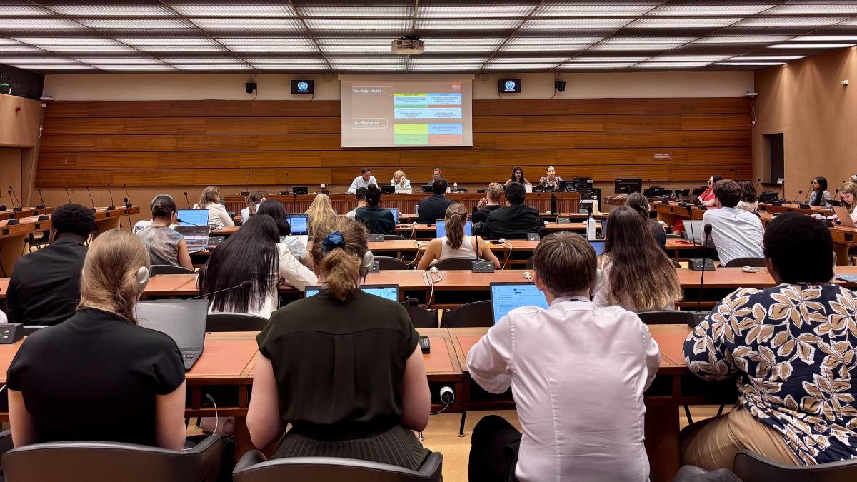 This photo shows an audience in a conference room at UN Geneva, listening to young graduate students present on the occasion of the UN's 80th anniversary.