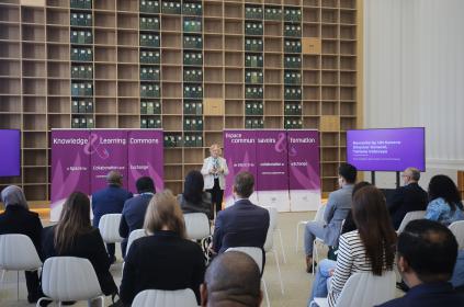 Picture of the director general of the UN Geneva speaking in front of a seated crowed