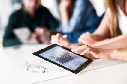 Group of young men and woman co wroking with a tablet 