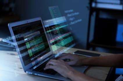 Programming background with a person working with codes on a computer