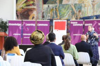 This image shows a group of diplomats listening to a speaker at an event at the Library & Archives.