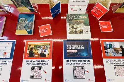 This image shows a large red table featuring posters and links to the Library's open access resources and digital services.